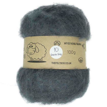 A carded batt of wool fiber in granite grey color, with a label indicating it is 100% organic wool weighing 100g.