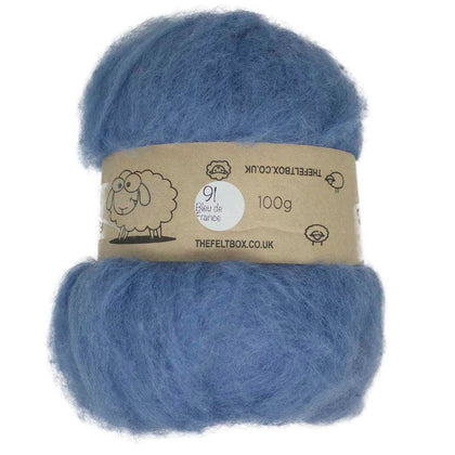 A carded bundle of blue wool batting, labeled with 'The Felt Box UK' and indicating 100% New Zealand wool