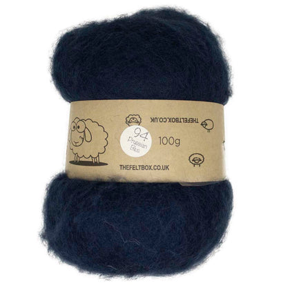 A carded bundle of navy blue wool batting, with a label indicating it is 100% sheep wool
