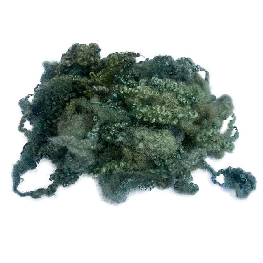 Clump of dark green fibers on a white background