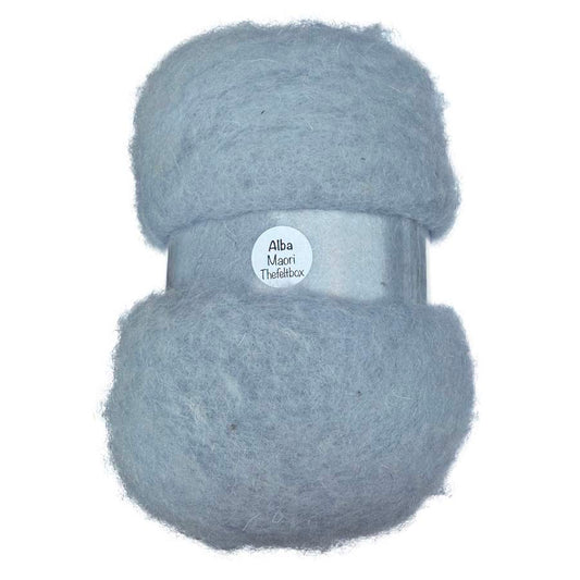 Ball of light blue carded wool  with a label the felt box on a white background