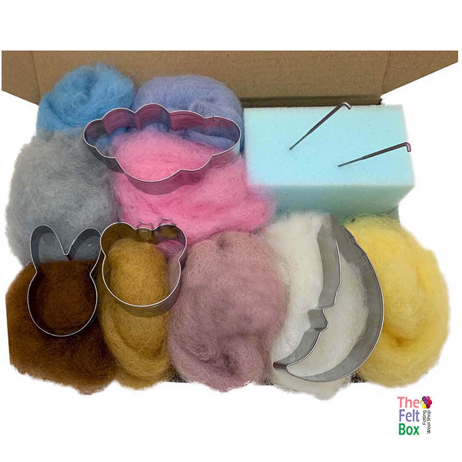 An open box of a needle felting kit for beginners showing various colored wool, cookie cutters, felting needles, and a foam mat.