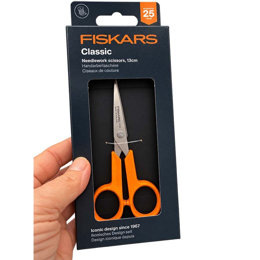A hand holding Fiskars Classic 13cm needlework scissors pack held in hand | The Felt Box