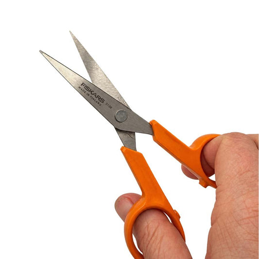 Fiskars 13cm needlework scissors with orange handles in hand | The Felt Box