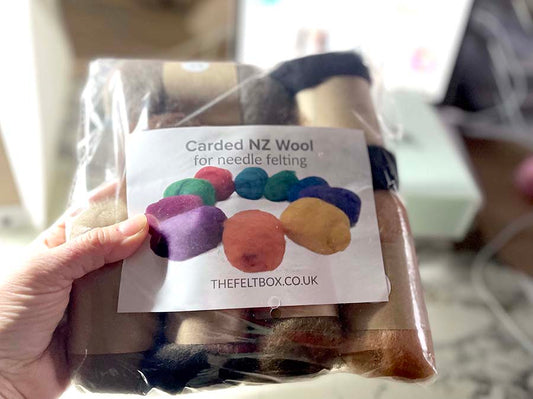 Rainbow carded wool shade packs in muted colours.