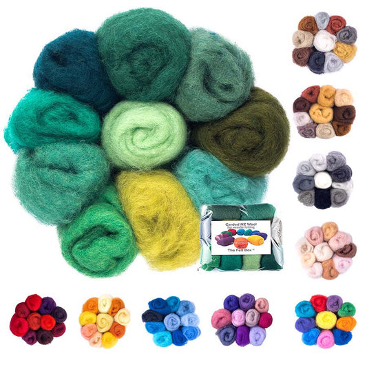 A collection of carded felting wool in various shades and colors, displayed as small rolls, with a label indicating the product is from The Felt Box.