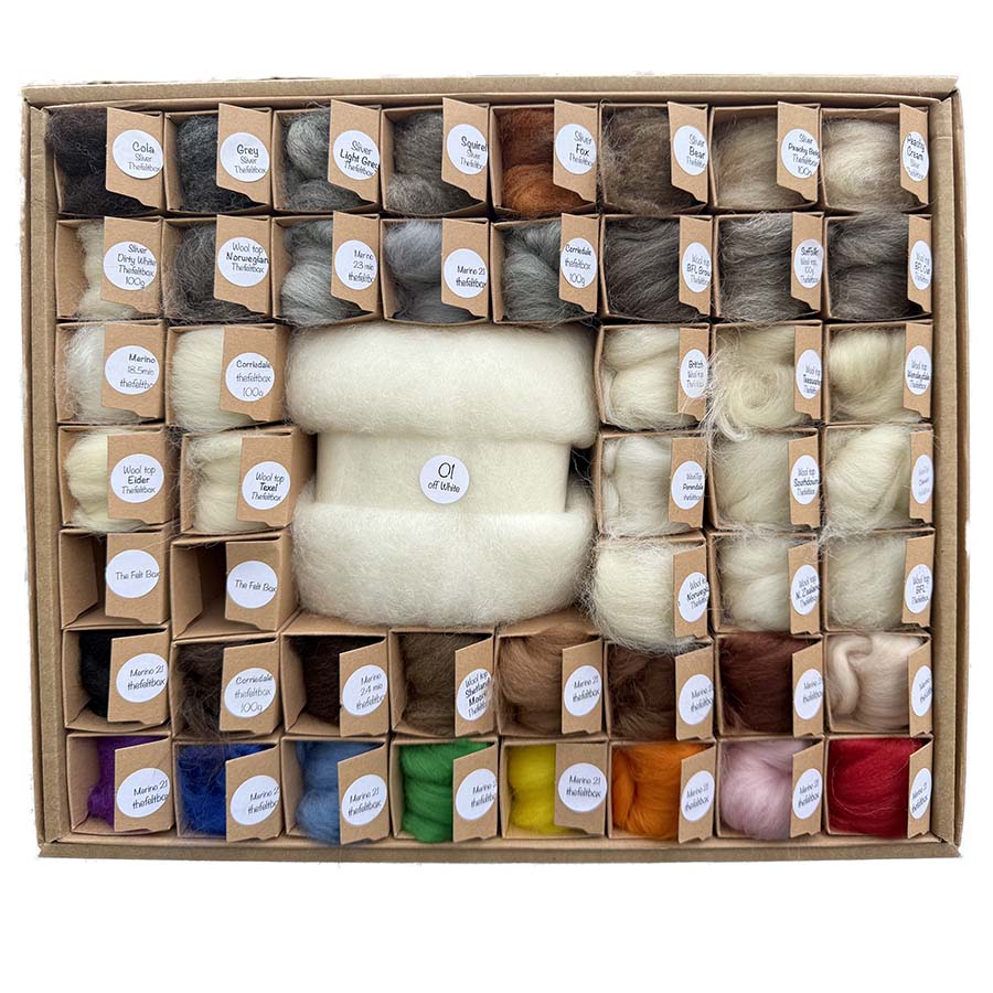 Assorted wool fibers in a box with labeled compartments.