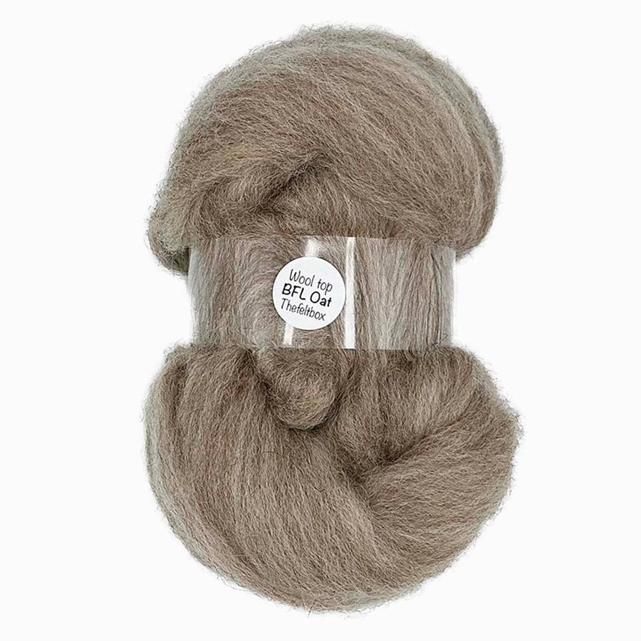 Ball of gray wool top with a label on a white background