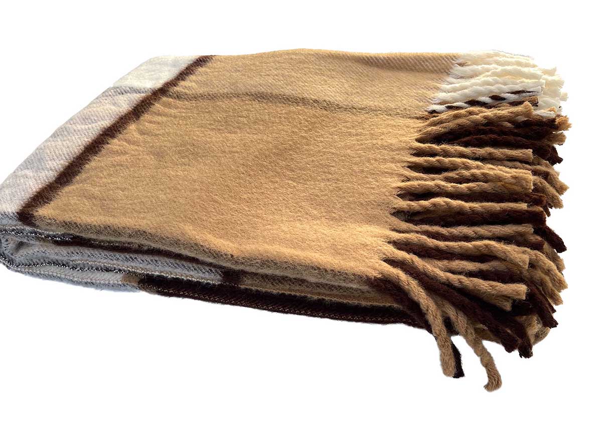 woolen brown throw in brown tartan style detail of tassel shown