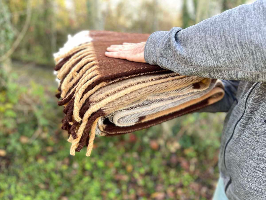 woolen brown throw in brown tartan style. Shown how thick it is
