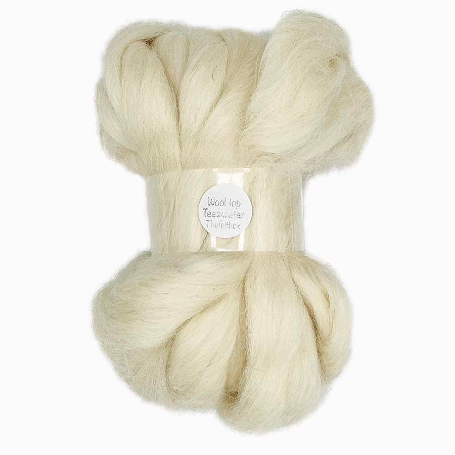 Cream-colored wool top on a white background