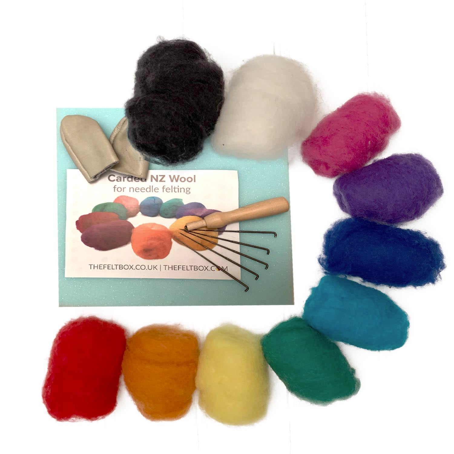 A collection of needle felting supplies including a variety of colored wool, felting needles, a foam mat, finger protectors, a wooden needle holder, and a packet of instructions.
