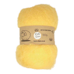 A carded yellow wool batt for needle felting, packaged in a cardboard box with a label featuring a sheep and product details.