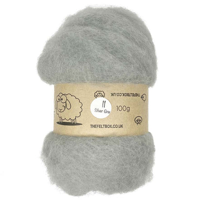 A carded bundle of silver grey wool batting, packaged with a label indicating it is 100% sheeps wool and weighing 100g.
