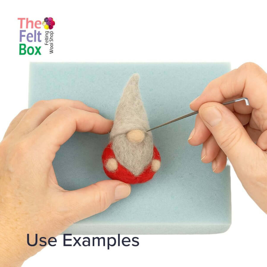 Felt gnome being worked on with a needle and light grey carded wool, branded 'The Felt Box'.