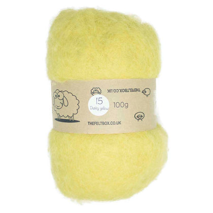 A bundle of dusky yellow carded wool batting for needle felting, displayed with a label indicating it is 100% sheeps wool from non-mulesed sheep, with a weight of 100g.