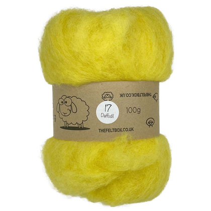 A bundle of yellow carded wool batting, packaged in a brown paper wrap with a label that includes the brand name 'The Felt Box' and the weight '100g'.