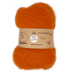 A bundle of carded NZ wool in dark orange, labelled as '100g' and marked with the number '35'.