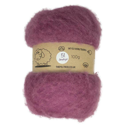 A carded wool batt in purple color, displayed on a card with branding and product information.