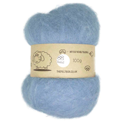 A bundle of blue carded wool batting for needle felting, displayed on a card with product information.