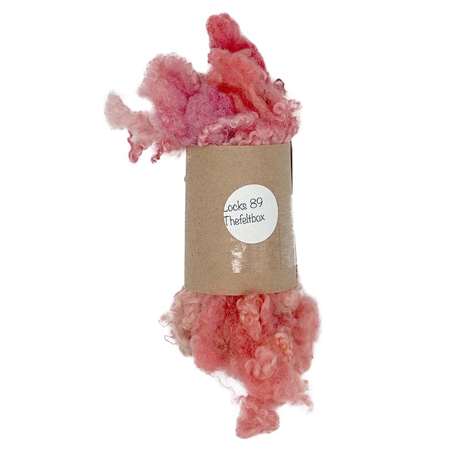pinkish-orange fluffy locks bfl against a white background