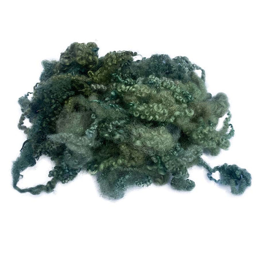 Clump of dark green fibers on a white background