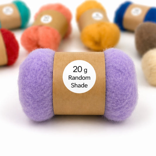 A random ball of carded felting wool with a label on a white background