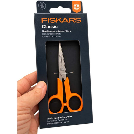 A hand holding Fiskars Classic 13cm needlework scissors pack held in hand | The Felt Box