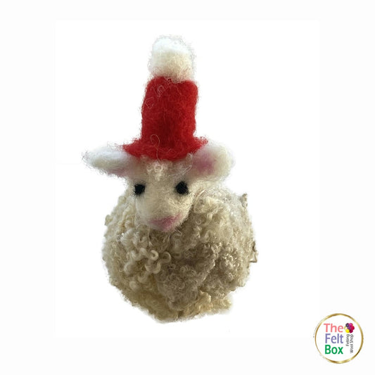 Finished needle-felted sheep wearing a red hat | The Felt Box