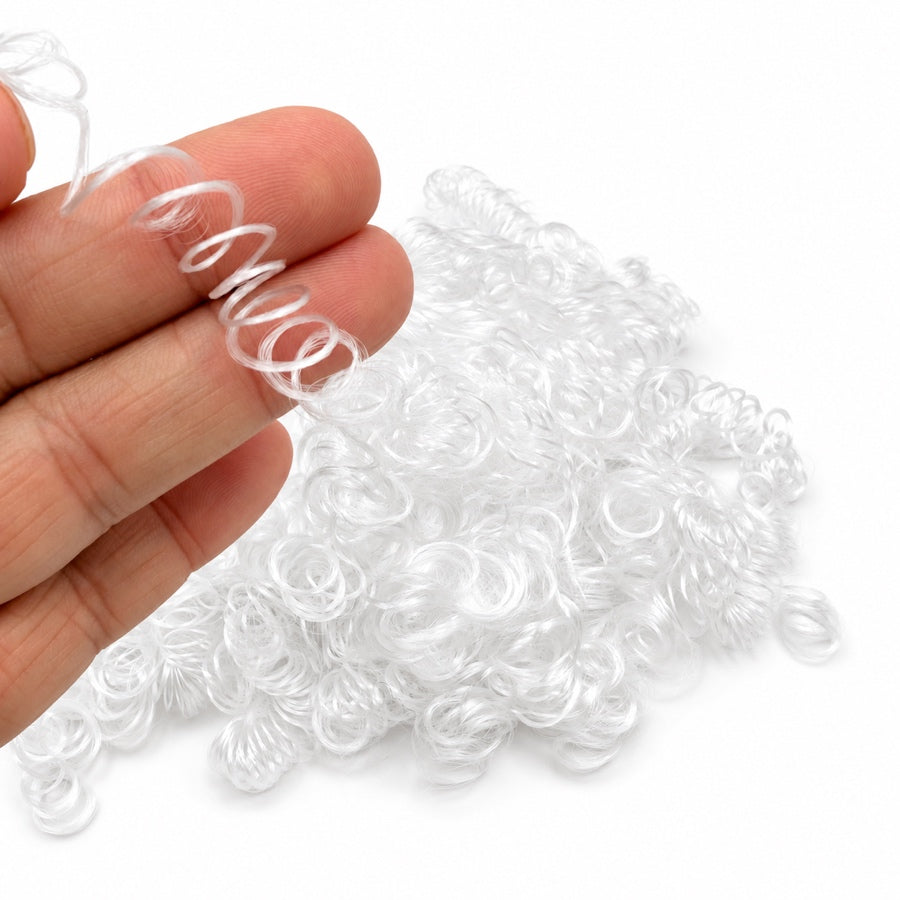 White curly vegan synthetic hair fibre held in hand, showing tight springy curls