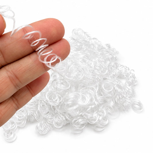 White curly vegan synthetic hair fibre held in hand, showing tight springy curls