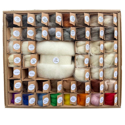 Assorted wool fibers in a box with labeled compartments.