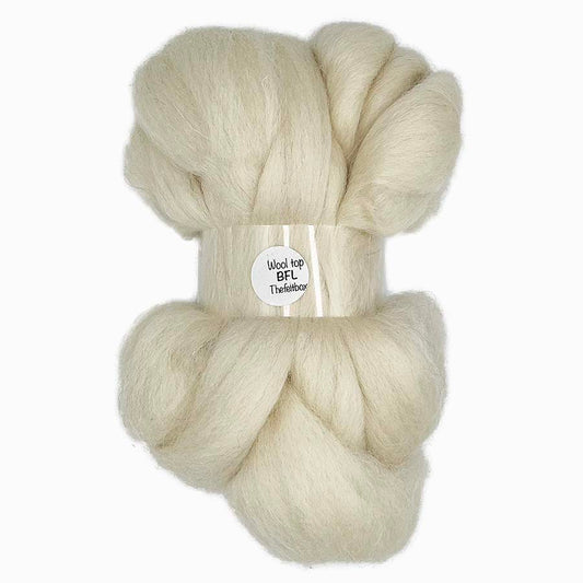 Soft cream Bluefaced Leicester wool top with a smooth, lustrous texture, ideal for spinning and needle felting