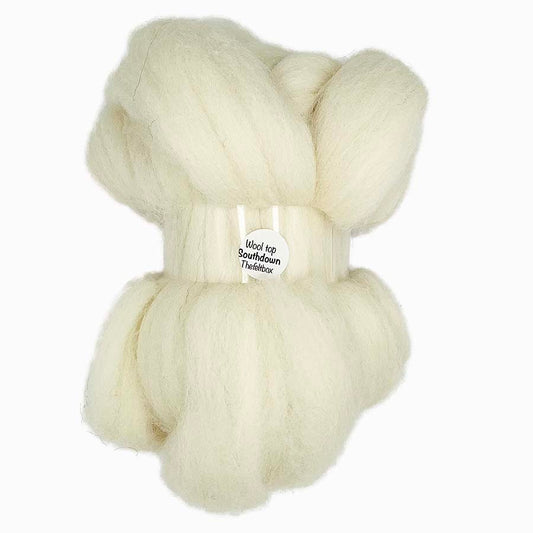 A bundle of natural creamy white wool top fibre, approximately 100g, displayed on a plain background with the watermark 'The Felt Box' across the image.